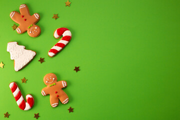 Tasty gingerbread cookies on red background. Copy space