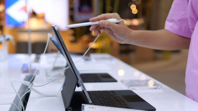 Modern buyer chooses graphics tablet from models in hardware store. Graphic designer buys best and most modern model for work. Modern professions impossible without use of technological innovations