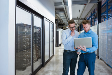 Coworkers working on laptop at industry