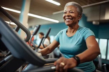 Fotobehang Elderly African American woman engaged in sports, gym fitness for seniors, healthy aging, active lifestyle © Pavel