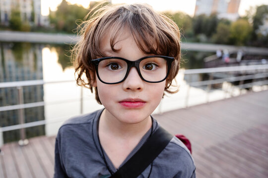 Cute boy wearing eyeglasses on bridge