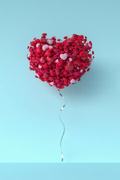 Balloon made from bunch of hearts levitating against blue background