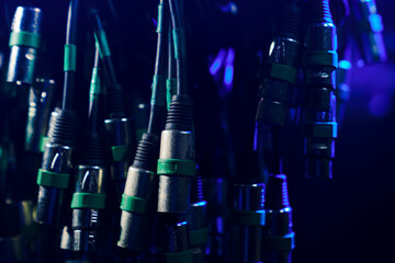 Close-up XLR cables for connecting concert equipment.