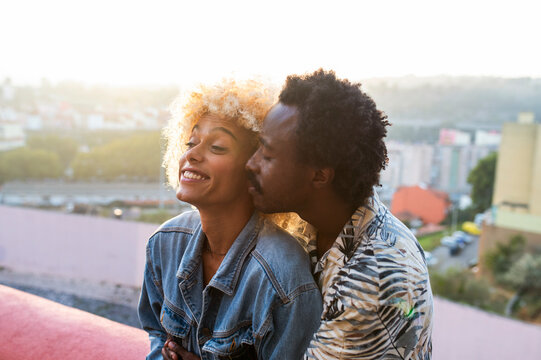 Romantic boyfriend embracing transgender woman on sunset