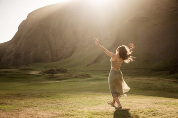 Girl dancing at sunset in Iceland