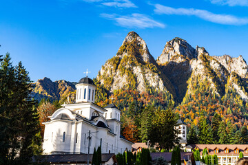 A Serene Church Amidst Majestic Mountain Peaks.A church in front of a mountain range