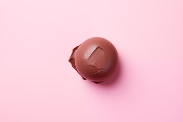 smeared ball of melted chocolate close up against a vivid pink background