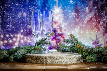 Champagne glasses on wooden table and empty space for your product. Winter landscape of mountains....