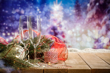 Champagne glasses on wooden table and empty space for your product. Winter landscape of mountains....