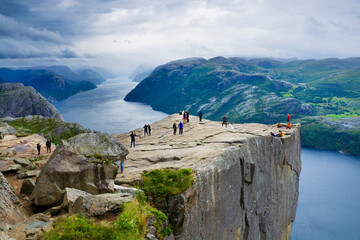 Preikestolen and surrounding area, Norway. Lysefjorden below. Unrecognizable people. - 688026353
