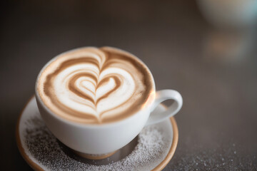 Obraz premium Cup of cappuccino with latte art on wooden background. Generative AI