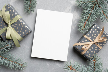 Fototapeta na wymiar Blank Christmas or New Year card mockup with decorated gift boxes