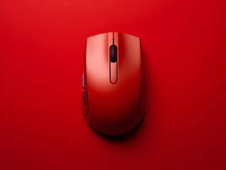 A red wireless computer mouse on red background, studio shot, top view
