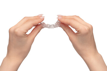 Transparent mouth guard in a woman's hand isolated.
