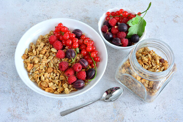 granola with fresh berries in white bowl top view  