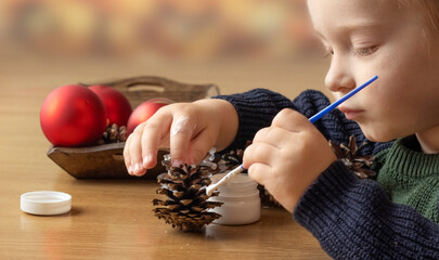 Christmas decor made from natural materials. Christmas decorations made from pine cones. Children's creativity