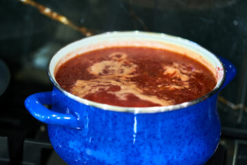 Ukrainian borscht in a pan stands on the stove