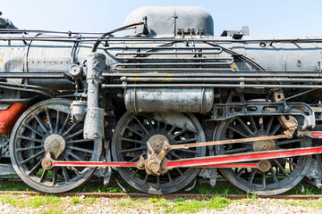 Obraz premium Close-up of the steam train wheels outdoors in Taiwan presents strength and beauty.
