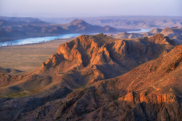 beautiful and big Steppe mountains near the big Ili river in Kazakhstan, view from top at sunset