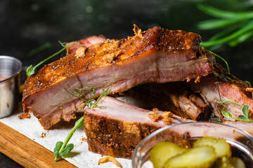 Grilled pork ribs on a wooden board with sauce