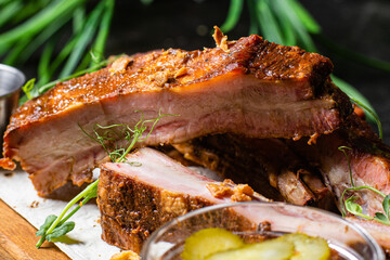 Grilled pork ribs on a wooden board with sauce