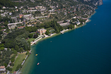 The city is located on the shores of Lake Garda. Panoramic aerial view of the city of Gargnano located on Lake Garda Italy. Coastline of the resort town of Gargnano Lake Garda Italy.