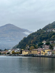 Fototapeta na wymiar Ancient colorful villas in Domaso on Lake Como at the foot of the mountains. Italy
