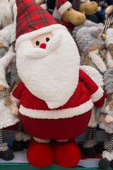 New Year's soft toys. Santa Claus with a sleigh and a gift bag, a Christmas toy on a shelf in the store
