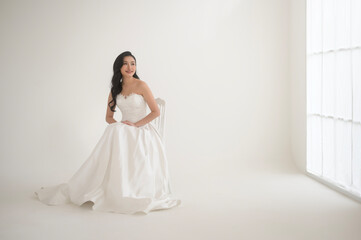 Fototapeta premium Portrait of beautiful bride with makeup and hairstyle in elegant wedding dress, wedding ceremony