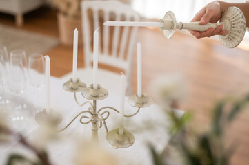 Close up of Bride and groom holding wedding candle during engagement ceremony