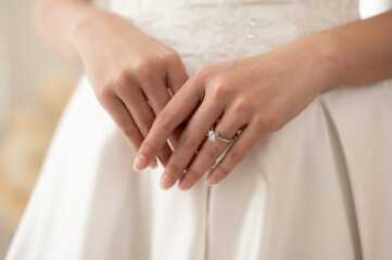 Obraz na płótnie Canvas Close up of elegant wedding ring on the bride's finger, Love and marriage concept