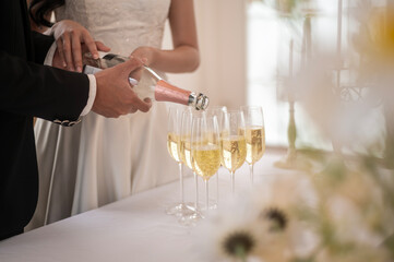 Bride and groom holding glasses of champagne at the wedding ceremony