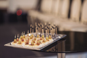 Closeup view photography of many small souffle cakes served on plate on table for cocktail party or on shelves of store. Christmas, birthday or wedding holiday dinner. catering food. tasty dessert.