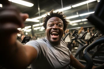 Fotobehang Obese African-Ameoverweight happy man with belly taking selfie at gym club, fitness center before training. Active lifestyle, loosing weigh by cardiot, getting fit, fitness, healthy habits concept © Valeriia