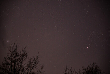 The constellation Orion and its belt in the dark night sky. Details of the Messier 42 Nebula and...