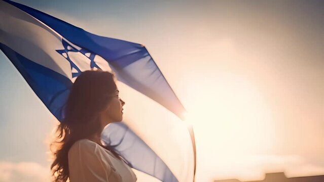 Woman raising flag of Israel. feminism,human rights,conflict Palestina concept. Jewish girl standing with the flag of Israel on the amazing valley and city and sky background. Memorial day-Yom,