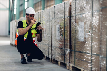 Warehouse worker working in warehouse storage. Foreman or worker work at factory site check up products in site. Inventory worker working in  factory Storehouse