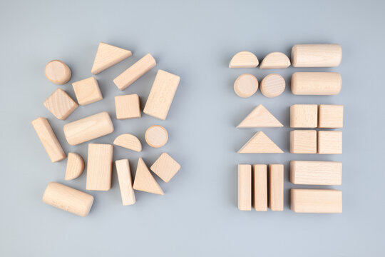 Many different geometric wooden toys in confused positions on the left, rearranged into the same types on the right, category, classification concept