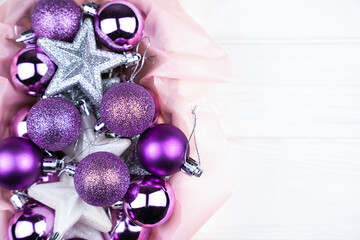 Christmas decorations on a white wooden background. New Year and Christmas holidays. Top view. Copy space. Close-up. Selective focus.