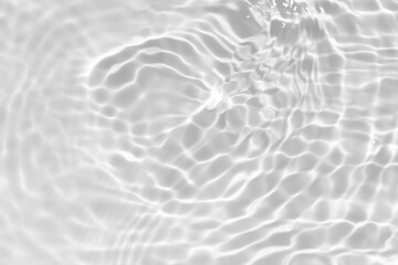 White water with ripples on the surface. Defocus blurred transparent white colored clear calm water surface texture with splashes and bubbles. Water waves with shining pattern texture background.