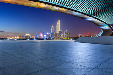City square and skyline with modern buildings at night in Suzhou, Jiangsu Province, China. Empty...