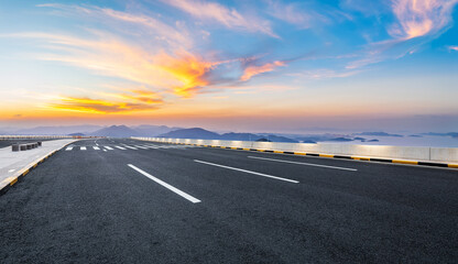 Asphalt highway road and mountain natural landscape at sunset. High Angle view.