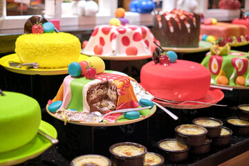 Cakes and pastries fill the frame with tempting hues. They represent a celebration of taste amidst...