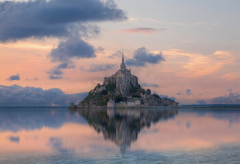 Mont Saint-Michel with water reflection at sunset, surrounded by sea, tidy islands, France,...