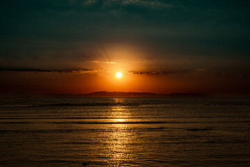 Tranquil Sunset Reflection on Calm Ocean Horizon