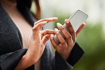Cropped image of young Black woman hands in business wear holding cell phone 