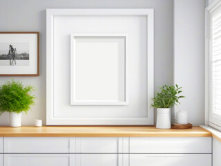Blank big white frame on white wall, cute minimalistic photo template. Green plant in a vase on a wooden tabletop, kitchen decor.