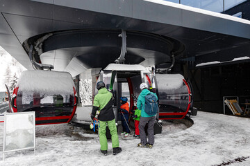 family of skiers taking the gondola - 688083987