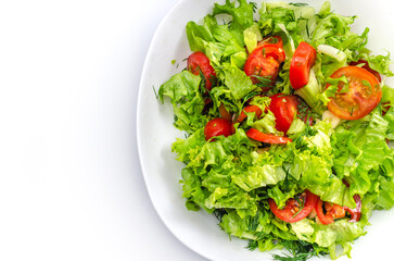 White bowl of chopped vegetables - dill, tomatoes, lettuce. White background, isolated, copy space.