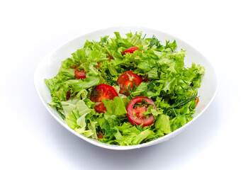White bowl of chopped vegetables - dill, tomatoes and lettuce. White background, isolated.